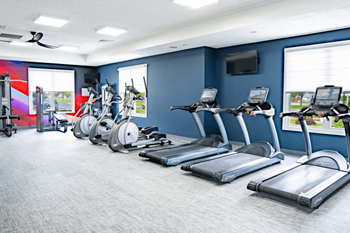 Gym with cardio equipment and weights in a room with windows at Waterstone Landing, Ohio